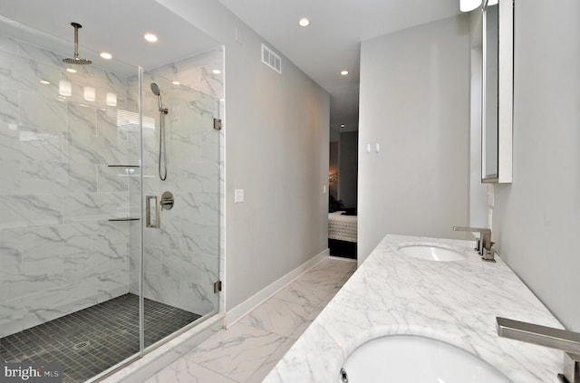 bathroom with a shower with shower door and vanity