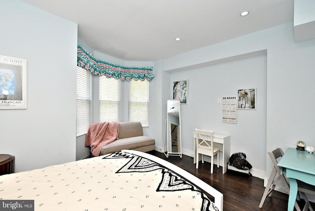 bedroom with dark hardwood / wood-style flooring