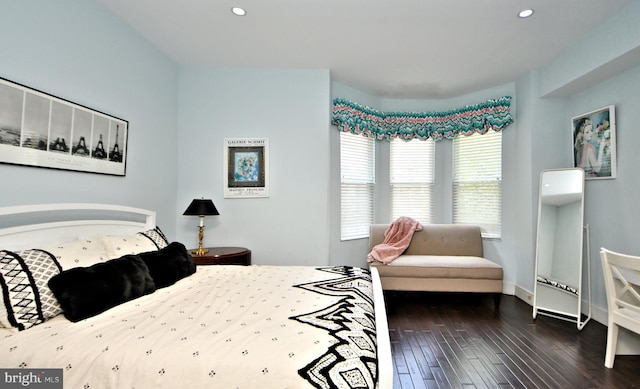 bedroom with dark hardwood / wood-style floors