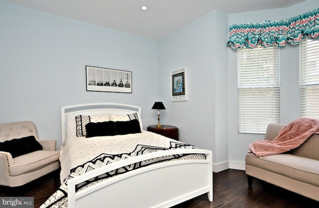 bedroom with dark hardwood / wood-style flooring