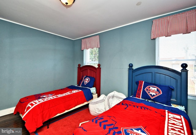 bedroom featuring hardwood / wood-style flooring and crown molding