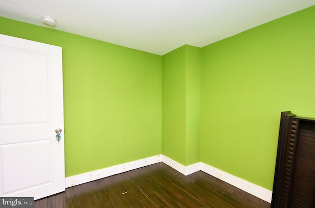 unfurnished room featuring dark hardwood / wood-style flooring