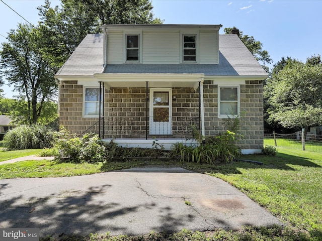 view of front of property with covered porch and a front yard