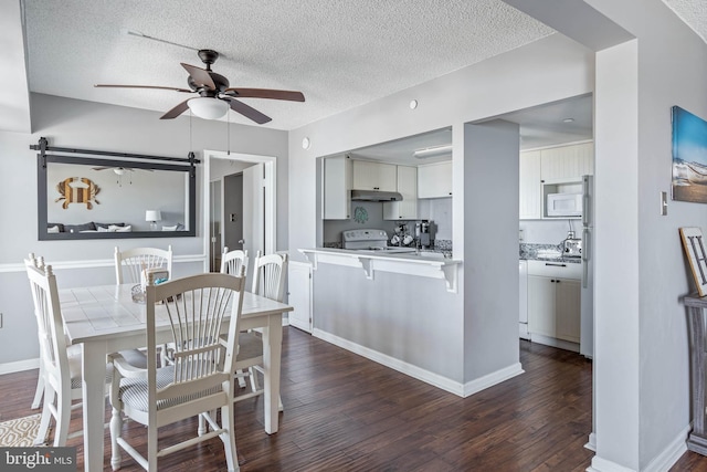 dining room with ceiling fan, dark wood-type flooring, and a textured ceiling