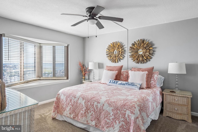 carpeted bedroom featuring a textured ceiling, ceiling fan, and baseboards