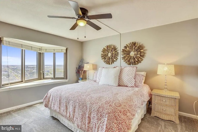 bedroom with carpet flooring, a ceiling fan, and baseboards