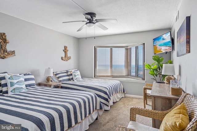 bedroom with a ceiling fan, light colored carpet, a textured ceiling, and baseboards