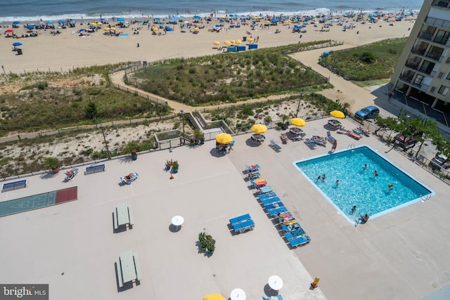 aerial view with a water view and a view of the beach