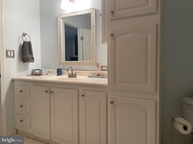 bathroom featuring vanity, toilet, and tile patterned floors