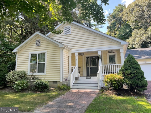 view of front of house featuring a porch and a garage