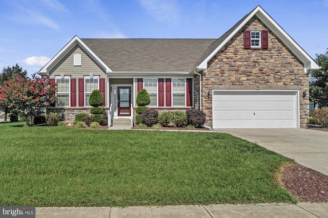 view of front of house with a front yard and a garage