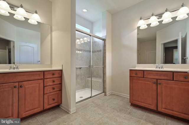 bathroom with vanity, a shower with door, and tile patterned flooring