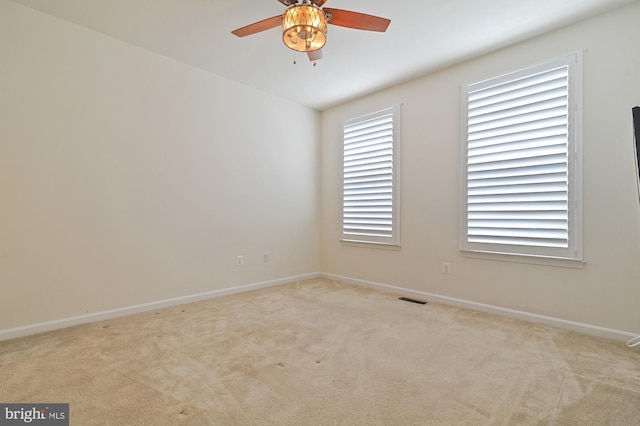 carpeted empty room featuring ceiling fan