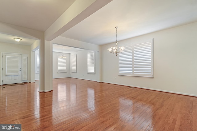 interior space with an inviting chandelier and hardwood / wood-style floors