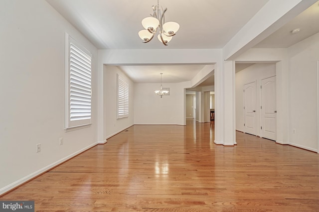 interior space with a notable chandelier and light wood-type flooring