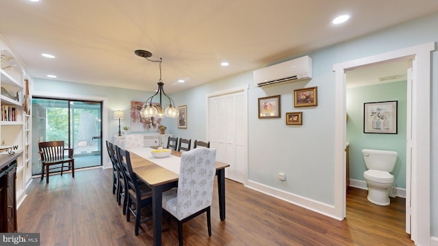 dining space with an AC wall unit and dark hardwood / wood-style flooring