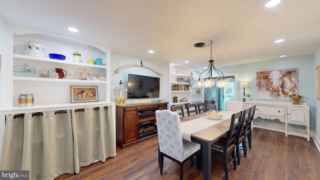 dining room with built in shelves and dark hardwood / wood-style floors