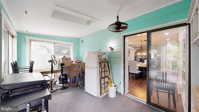 interior space featuring wood-type flooring and a chandelier