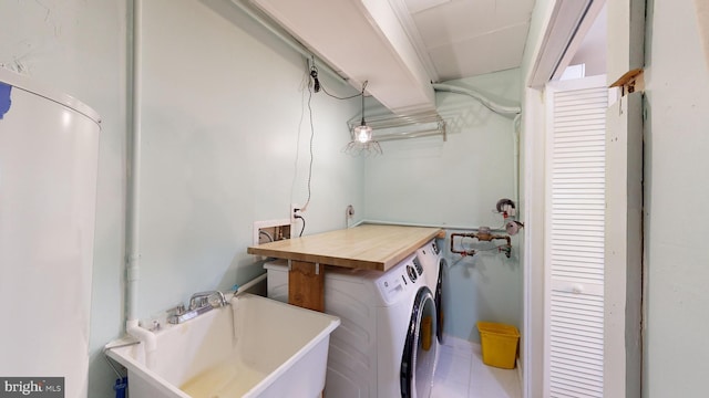 washroom featuring hookup for a washing machine, sink, and tile patterned floors