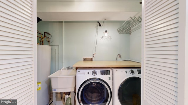 laundry room featuring sink, independent washer and dryer, and gas water heater