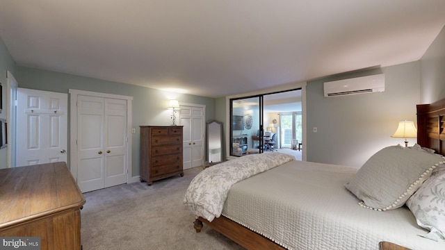 bedroom featuring light colored carpet and a wall mounted air conditioner