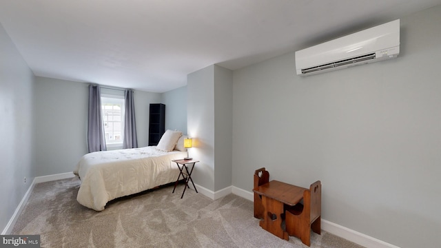 bedroom featuring a wall unit AC and carpet floors