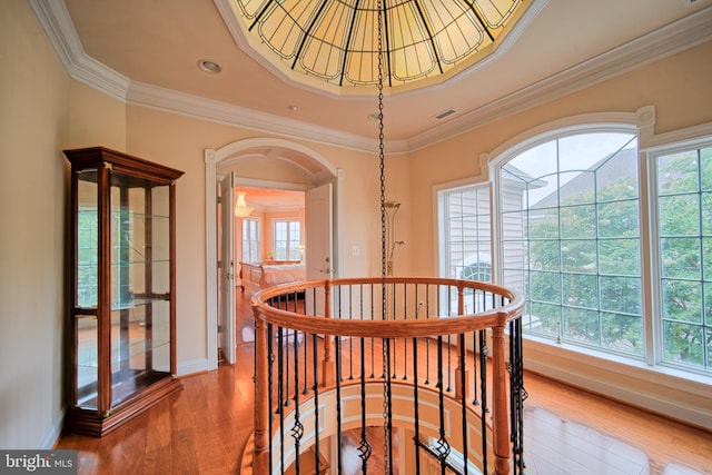 hallway with plenty of natural light, an upstairs landing, and wood finished floors