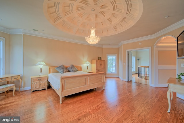 bedroom with a chandelier, light wood-type flooring, crown molding, and baseboards