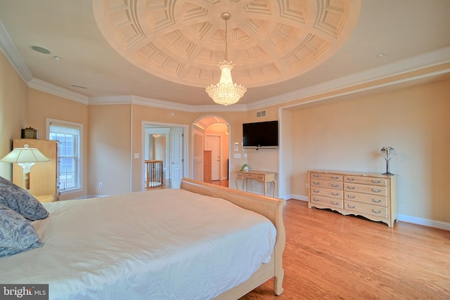 bedroom with baseboards, visible vents, wood finished floors, crown molding, and a notable chandelier