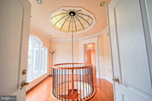 hallway featuring light wood finished floors, baseboards, ornamental molding, an upstairs landing, and recessed lighting