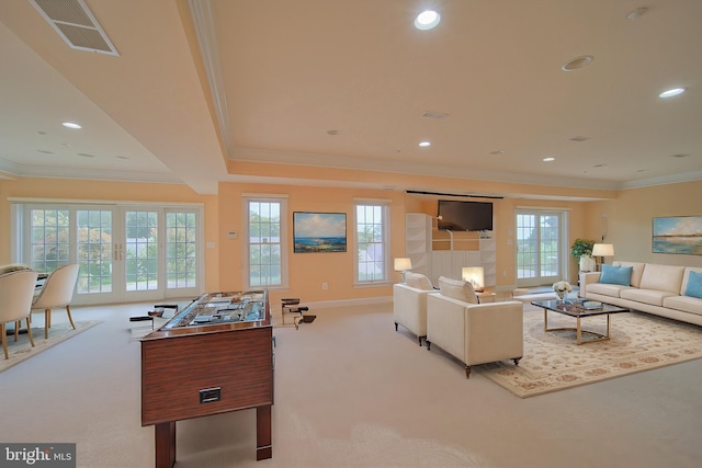 living area featuring recessed lighting, light carpet, visible vents, french doors, and ornamental molding