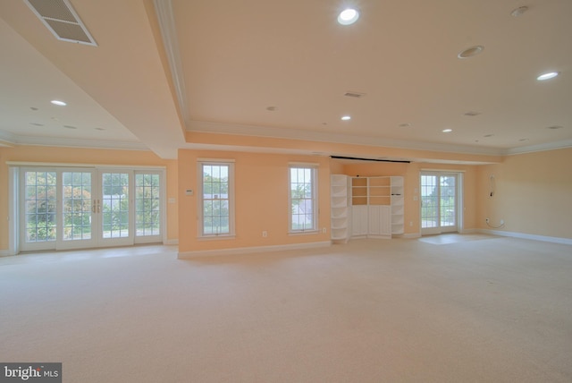 interior space featuring light carpet, ornamental molding, visible vents, and baseboards