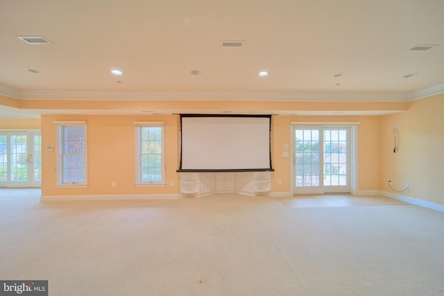 cinema featuring light carpet, ornamental molding, visible vents, and baseboards