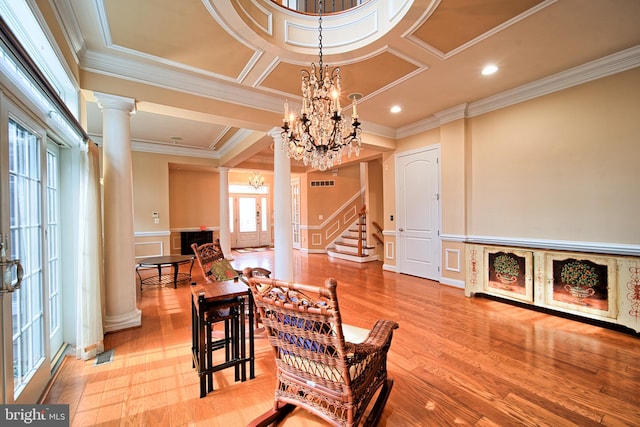 dining space featuring visible vents, stairway, ornate columns, a chandelier, and a decorative wall