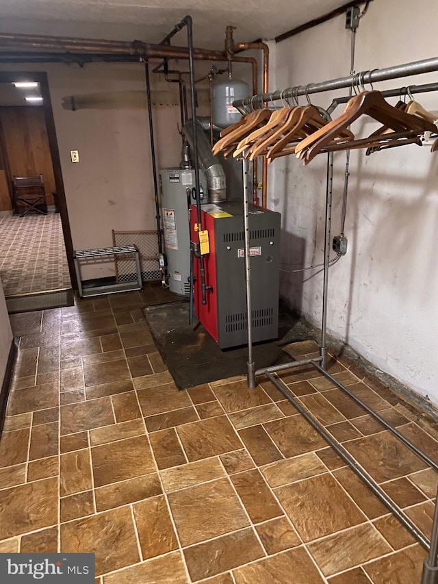 utility room with water heater and heating unit