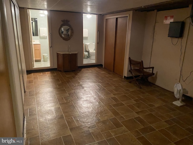 unfurnished living room featuring dark tile patterned floors