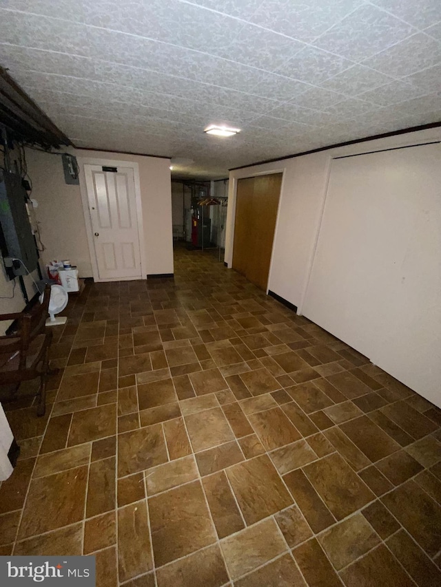 basement featuring dark tile patterned flooring