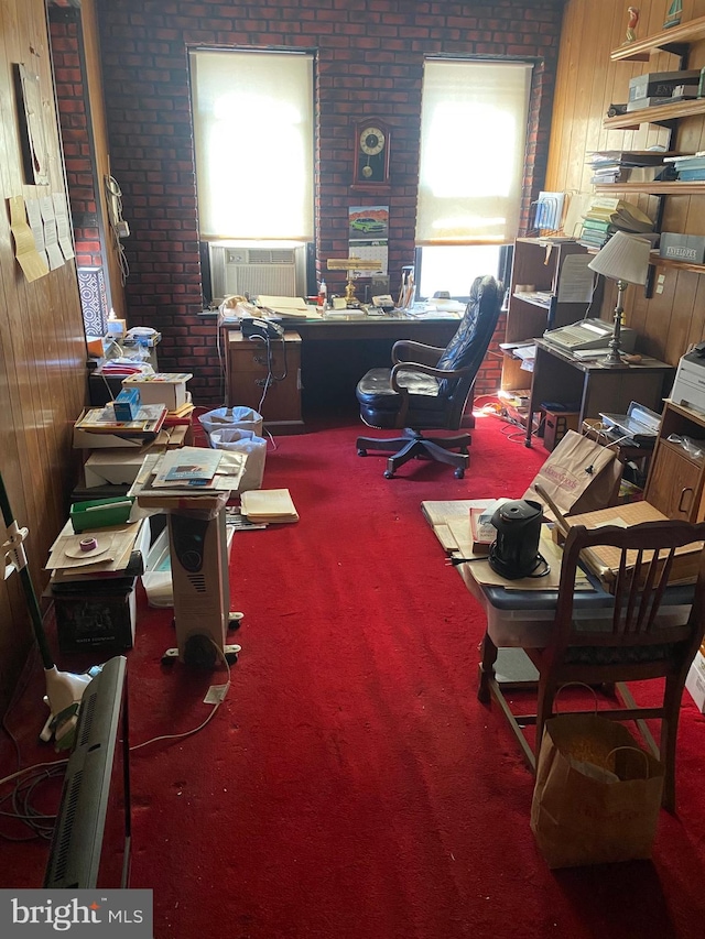 carpeted office featuring wood walls, cooling unit, and brick wall