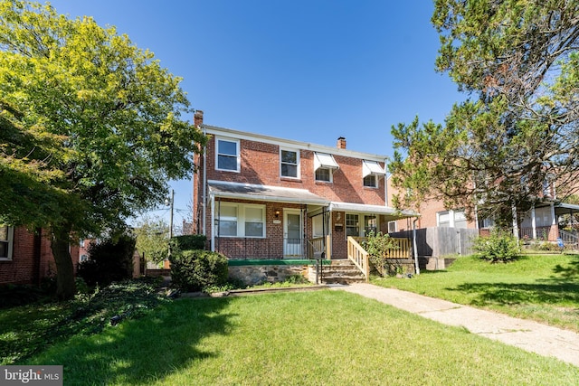 view of front of house with a porch and a front yard