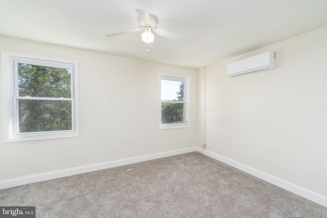 carpeted spare room with a wall mounted air conditioner and ceiling fan