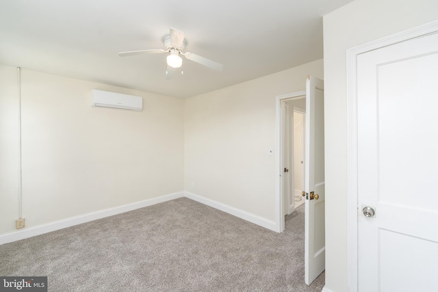 carpeted spare room with a wall mounted AC and ceiling fan