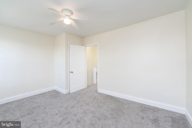 empty room with ceiling fan and carpet flooring