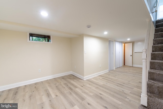 basement with light hardwood / wood-style floors