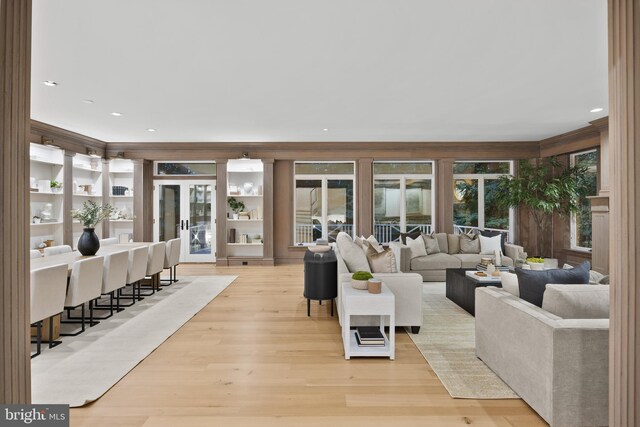 living room with light hardwood / wood-style flooring and french doors