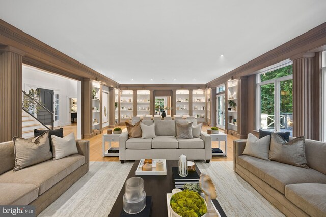 living room with light wood-type flooring and crown molding