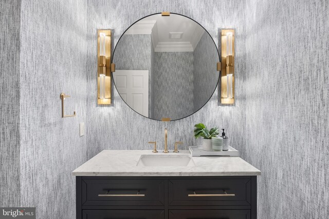 bathroom with crown molding and vanity