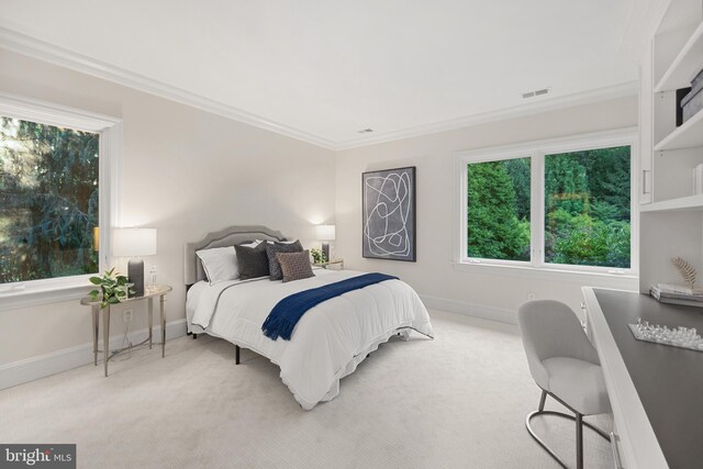 carpeted bedroom featuring ornamental molding