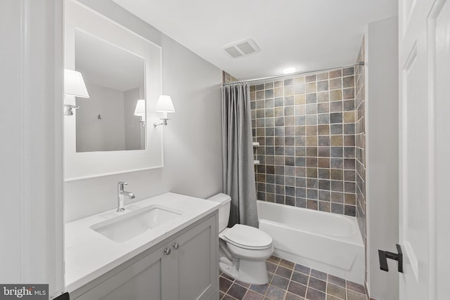 full bathroom featuring toilet, shower / tub combo with curtain, tile patterned floors, and vanity