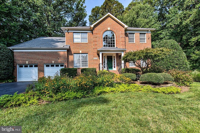 colonial-style house with a garage and a front yard