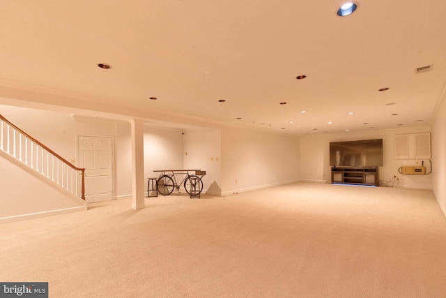 unfurnished living room featuring light carpet and ornamental molding